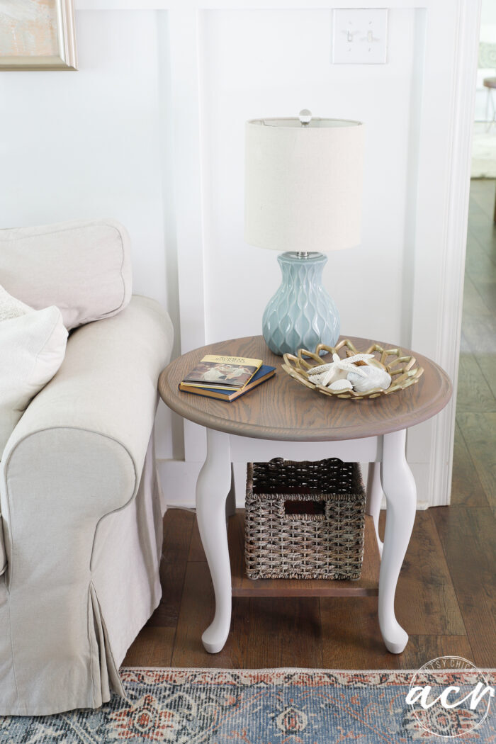 end table decorated with blue lamp beside tan couch