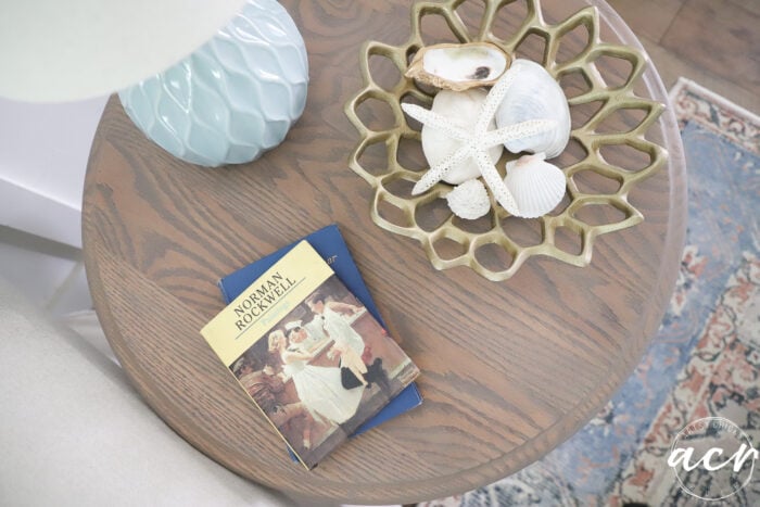 top view of finished table with books and bowl full of sea shells