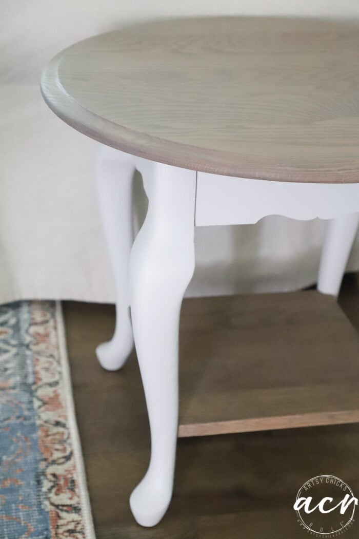 side view of finished table with off white legs, driftwood stained top