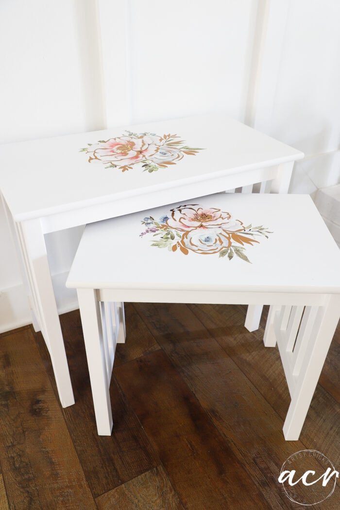 white nesting tables with pink and blue and gold flowers