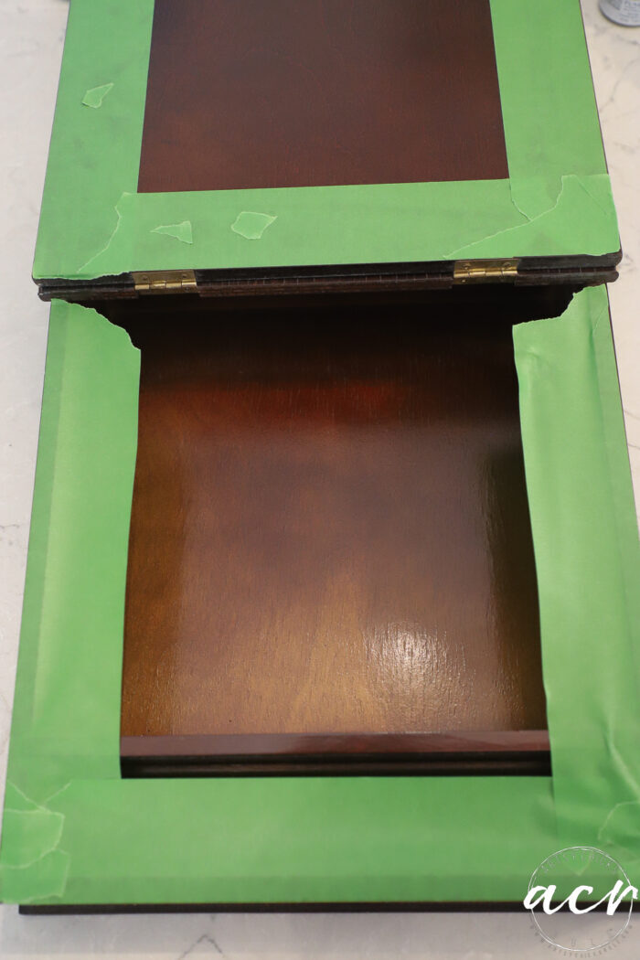 green tape on inside of wood box