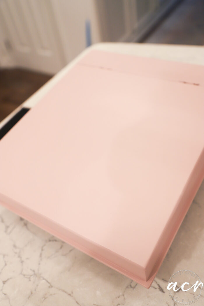 pink painted wood box on white counter