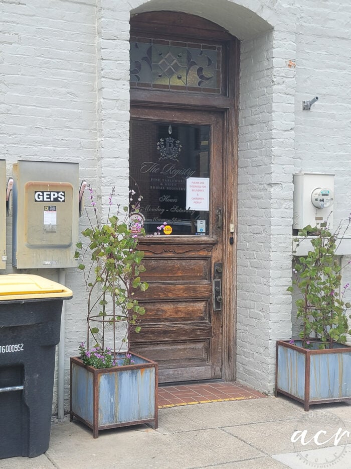 old wood and glass door with glass stained glass transom over top