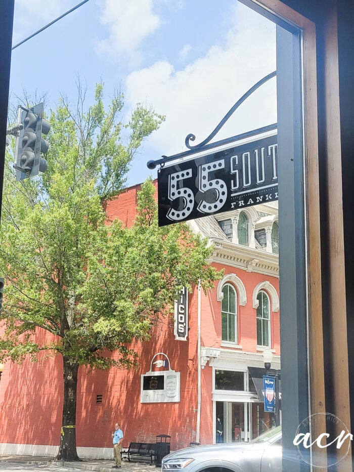 looking out window at 55 South sign