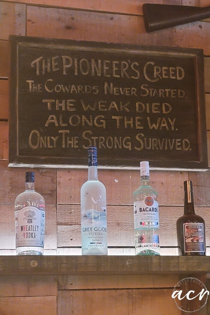 sign over bar with bottles