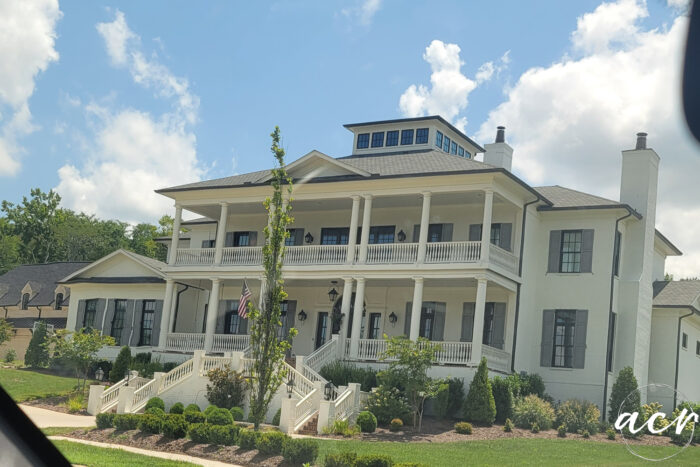 huge home with columns and large double porches