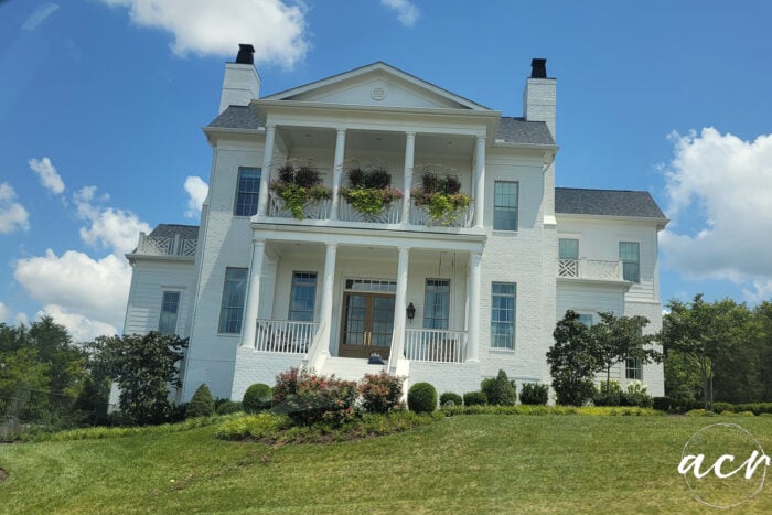 large white house with columns and double balconies on front