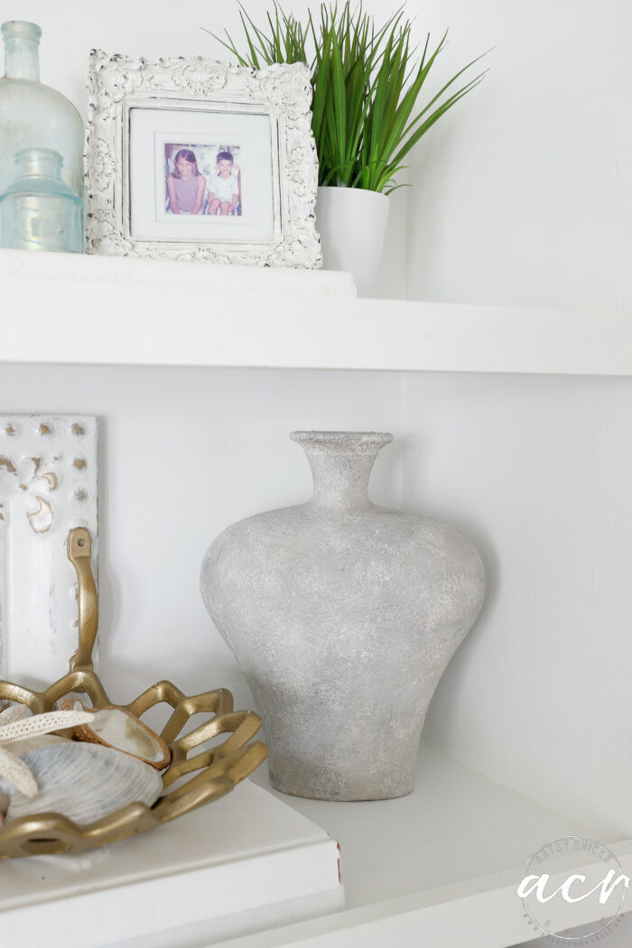 rustic textured vase on shelf with other decor