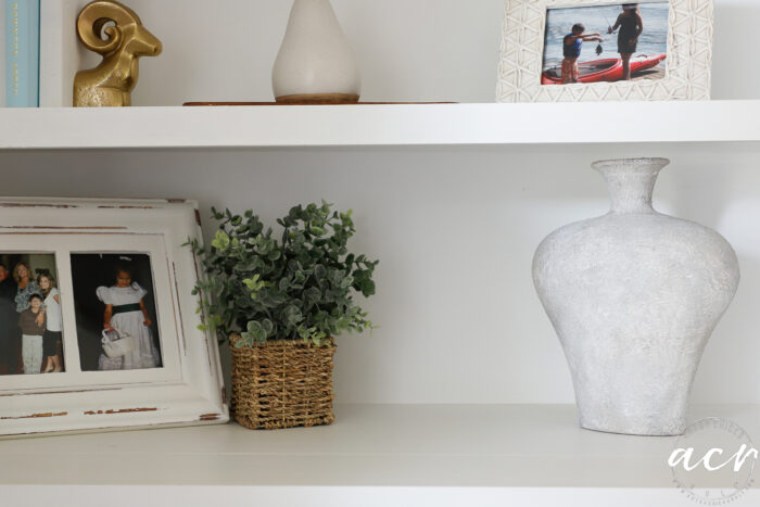 rustic vase on white shelf