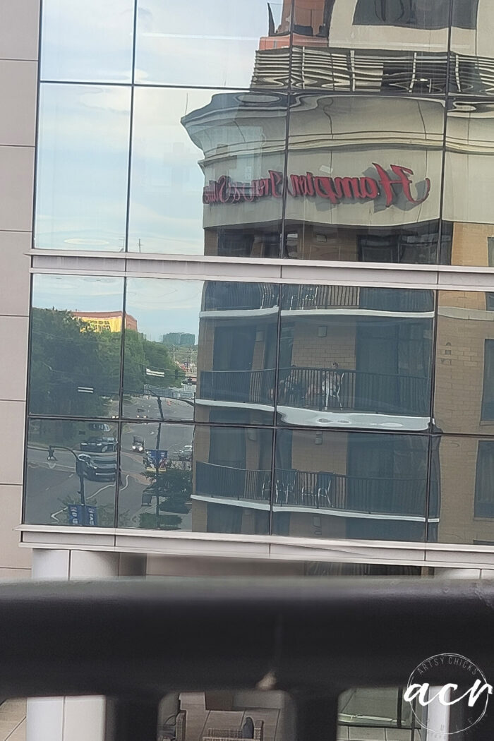 reflection in other building of balcony hampton inn