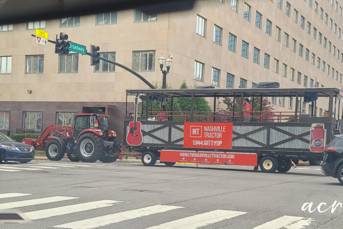 party bus pulled by red tractor