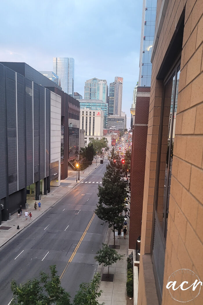 looking down street with large buildings