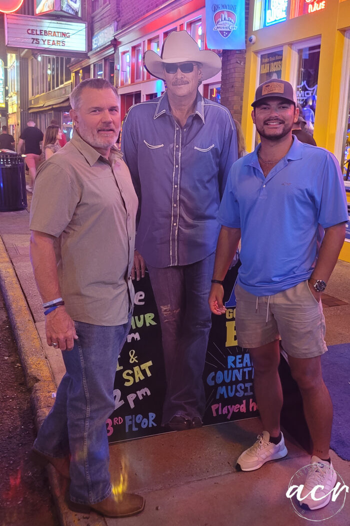 my husband and son with cardboard alan jackson