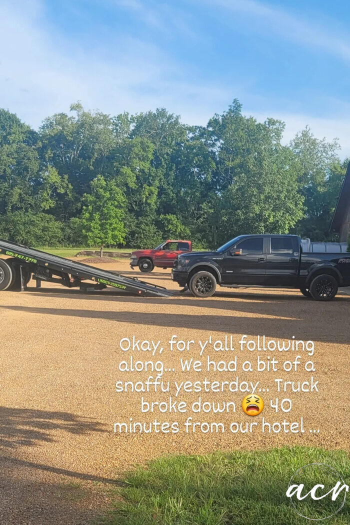 black truck going onto tow truck