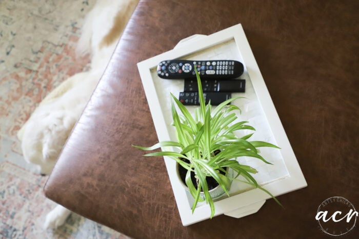 top view of brown ottoman and white tray