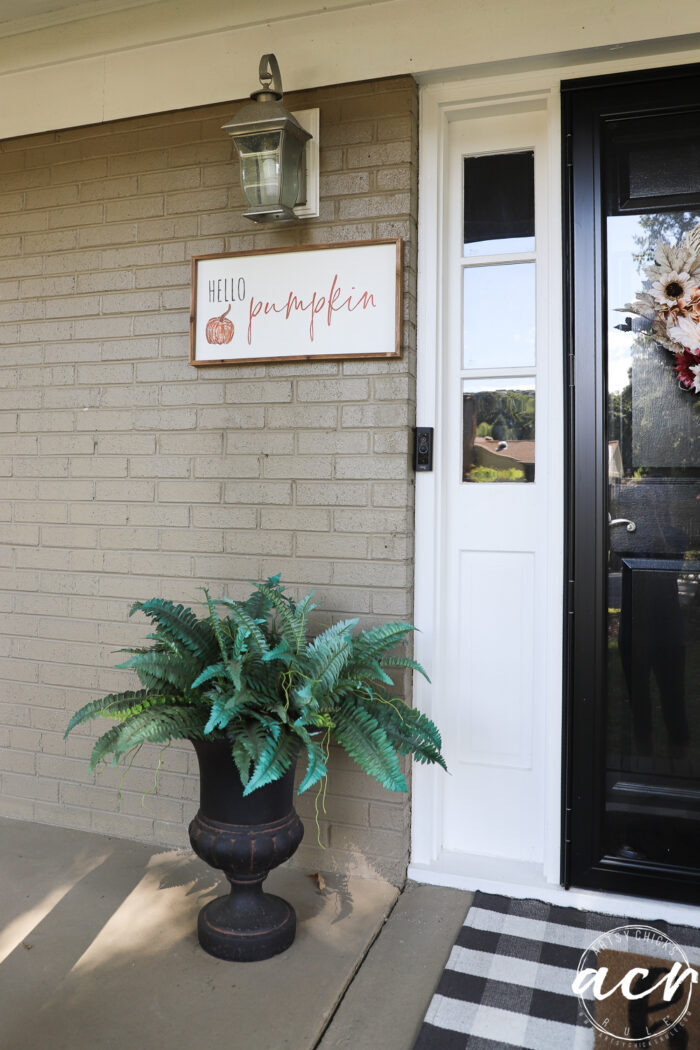 hello pumpkin sign on house by door 