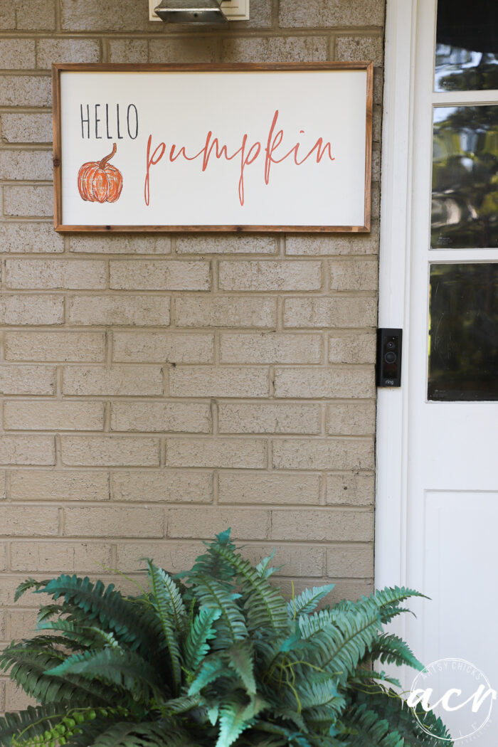 wood framed sign on porch wall