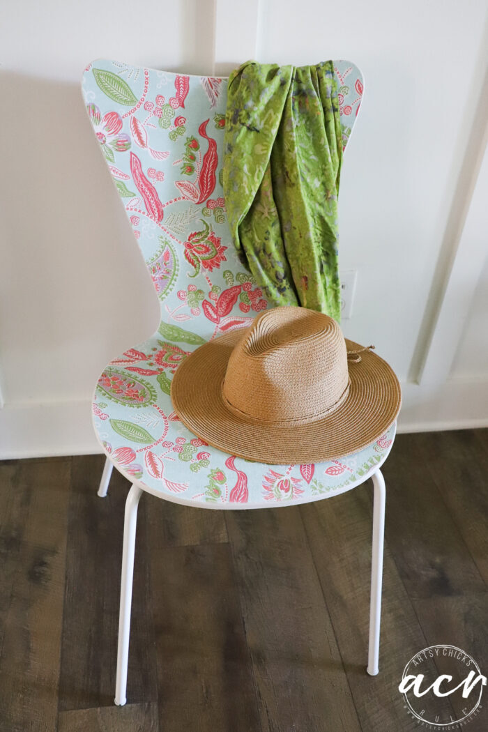 chair with green scarf and hat on seat