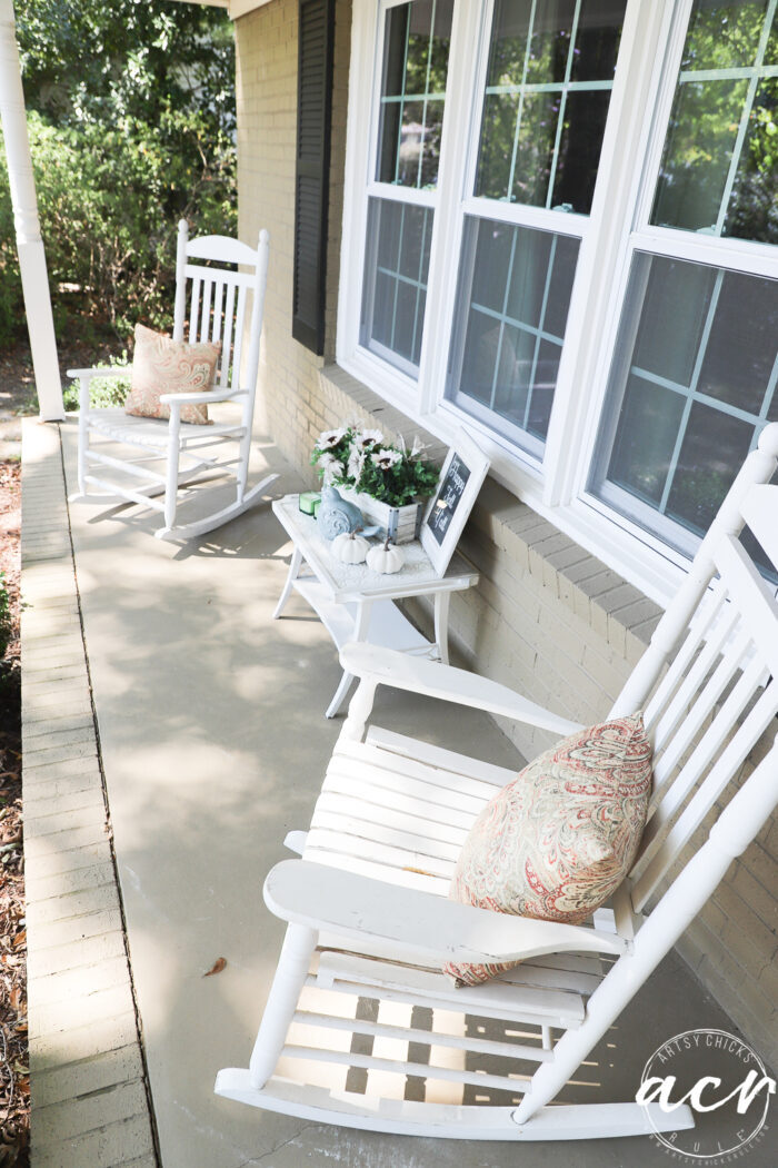 white rockers with pillows table in middle