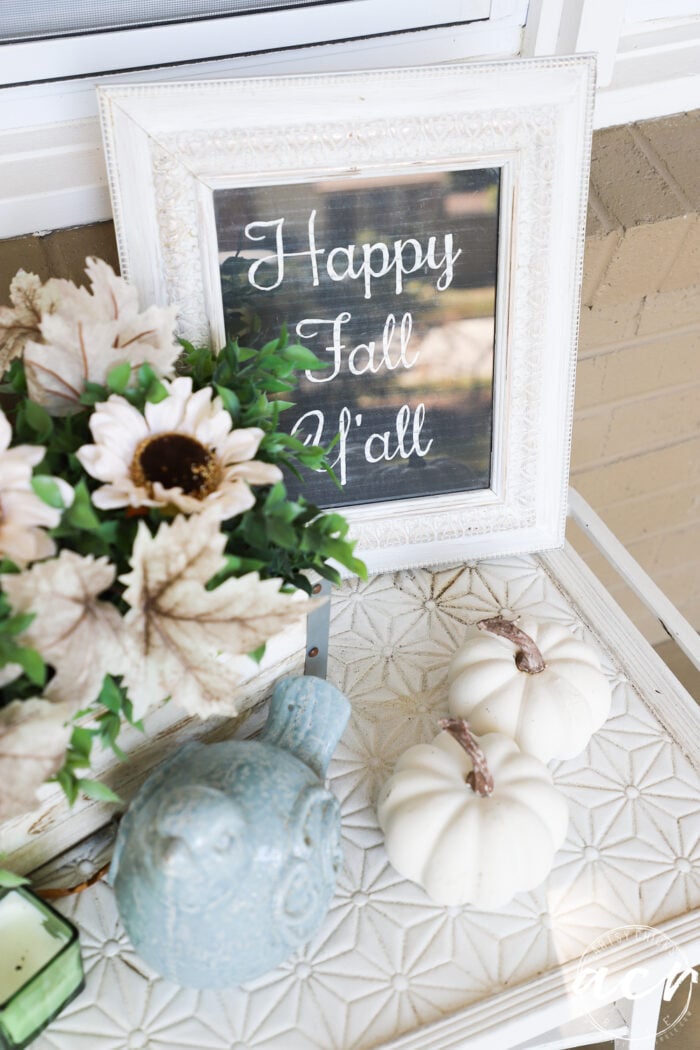 white tiled table with white pumpkins and happy fall y'all framed sign