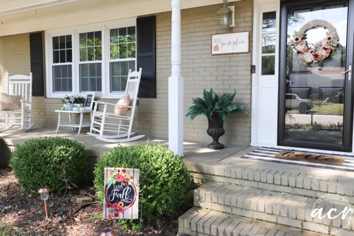 taupe colored home with black shutters and white trim