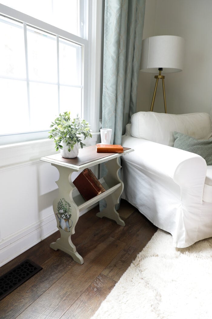 side view of white chair and side book table