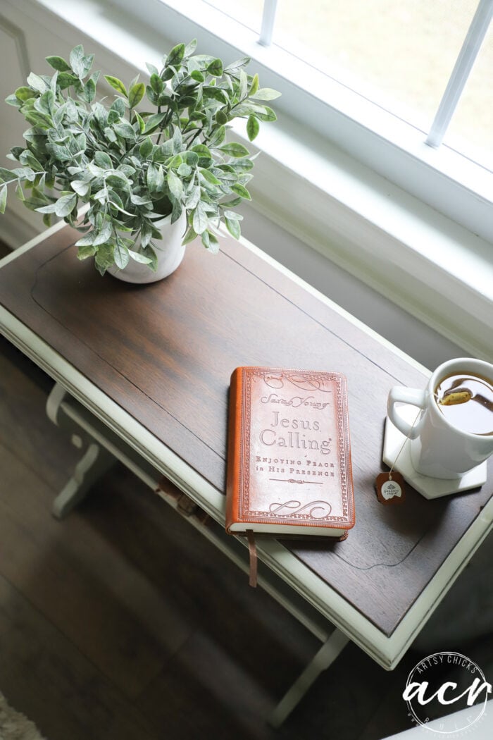 top view of table top with book plant and mug