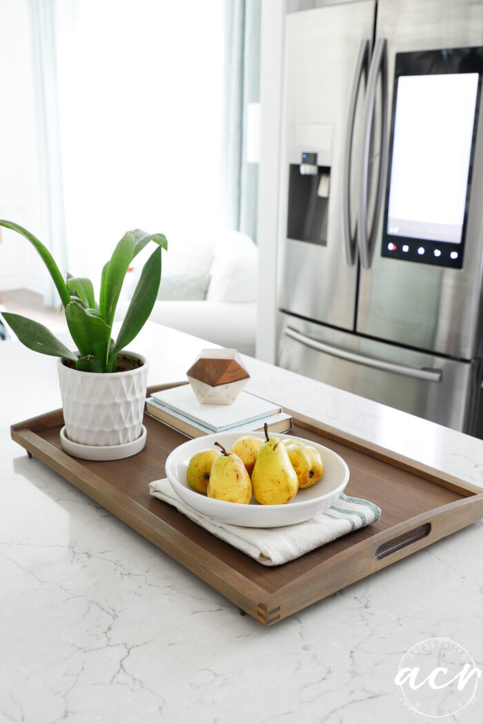 wood tray decorated with stainless fridge behind