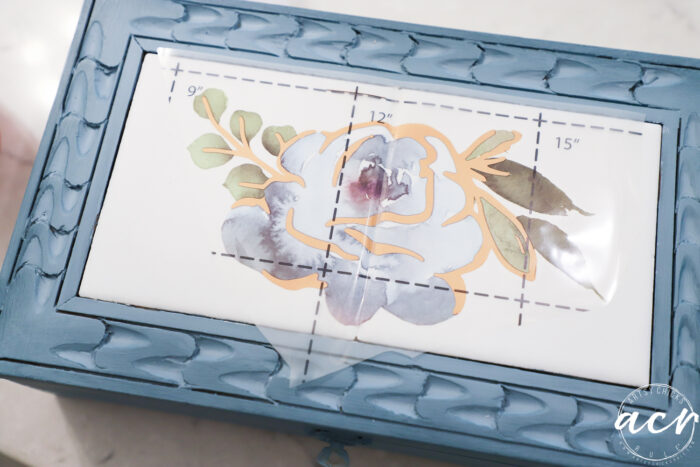 blue box with white tiles and blue floral transfer