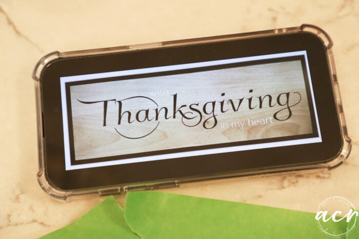 wood drawer front with thanksgiving image on phone
