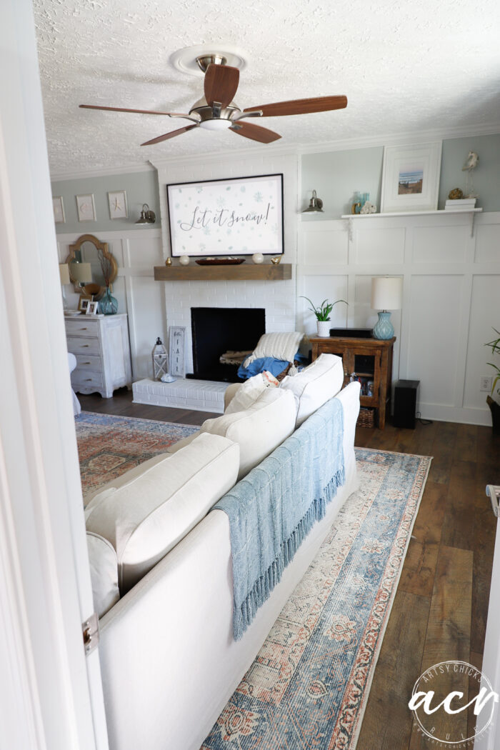 looking into living room from doorway behind couch