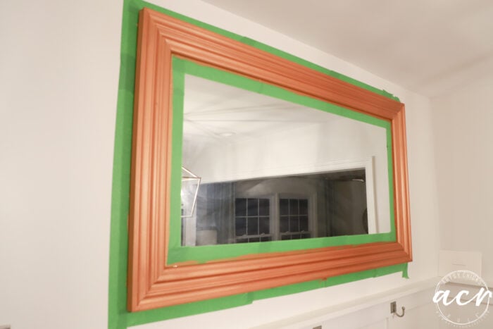 mirror on wall with frogtape and copper painted