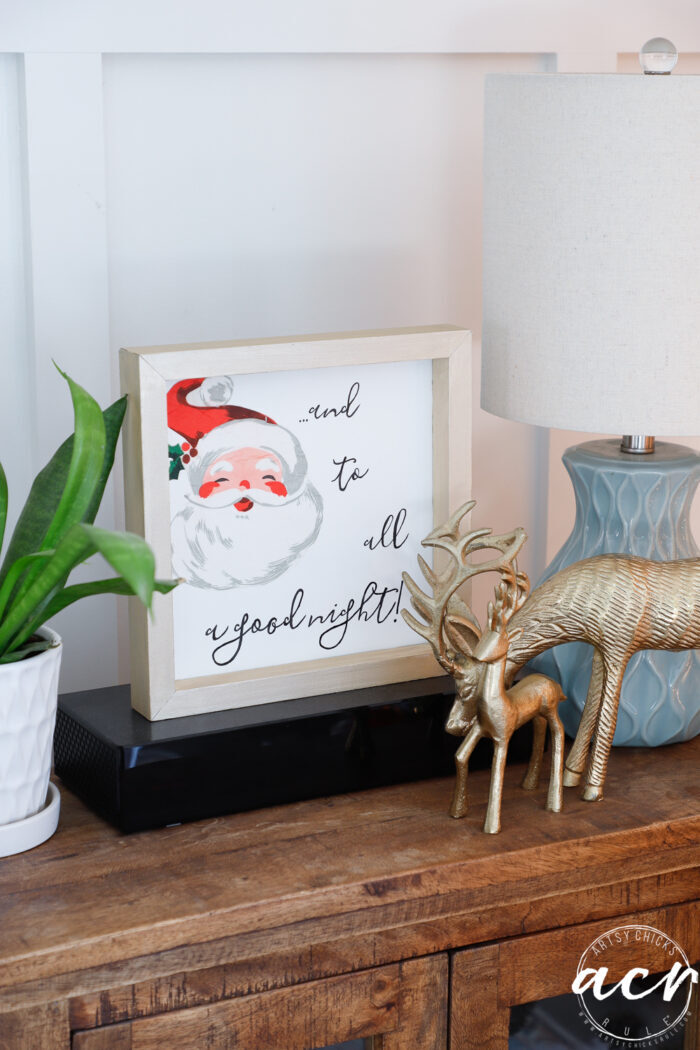 santa sign with gold deer and blue lamp