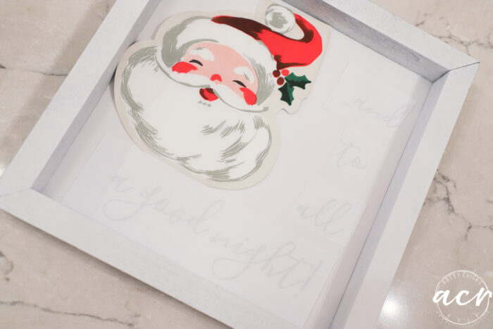 small sign painted white with santa napkin
