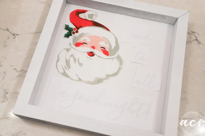 small white sign with santa napkin and printed words