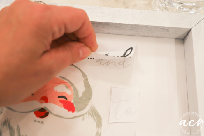 lifting up paper to show how ink transferred the lettering