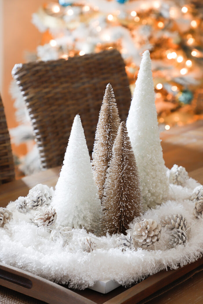 gold and white christmas trees with white furry "snow" around them