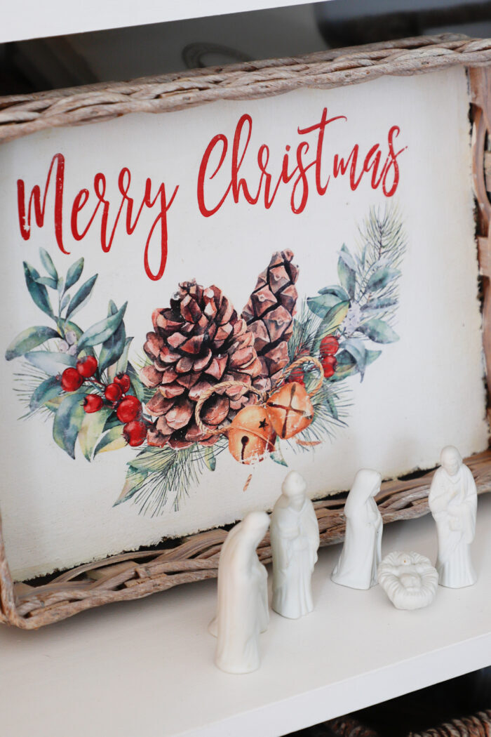merry christmas picture on tray with white ceramic nativity in front