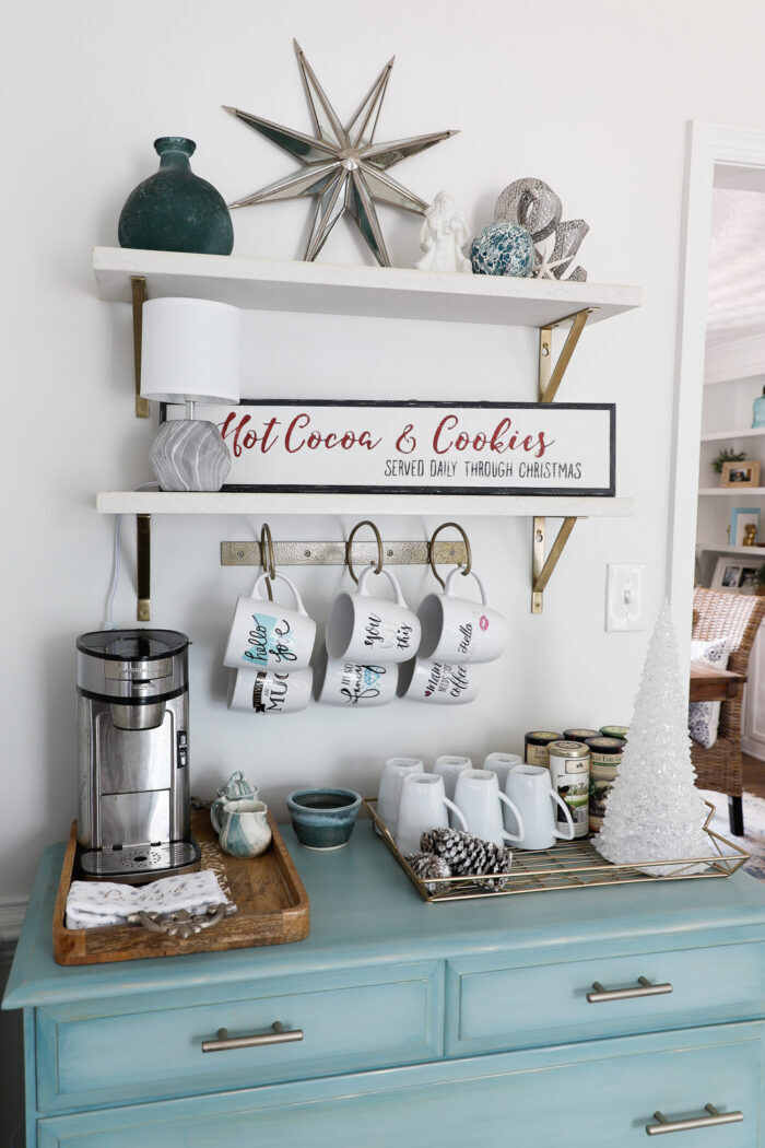 blue dresser with coffee bar items on top and shelves above