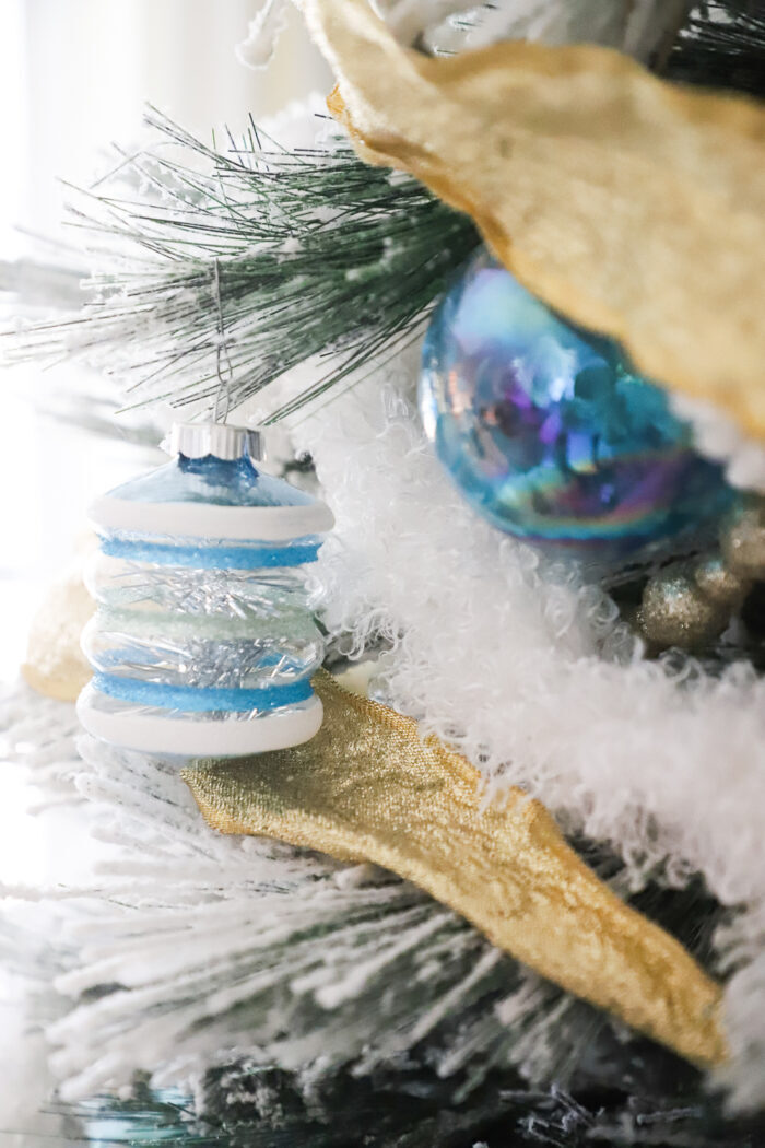 blue ornaments on tree up close