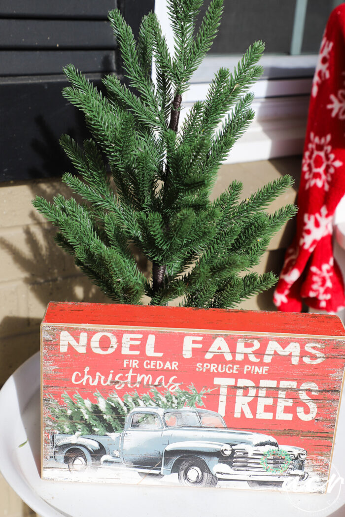 green pine tree and noel farms red sign on white table