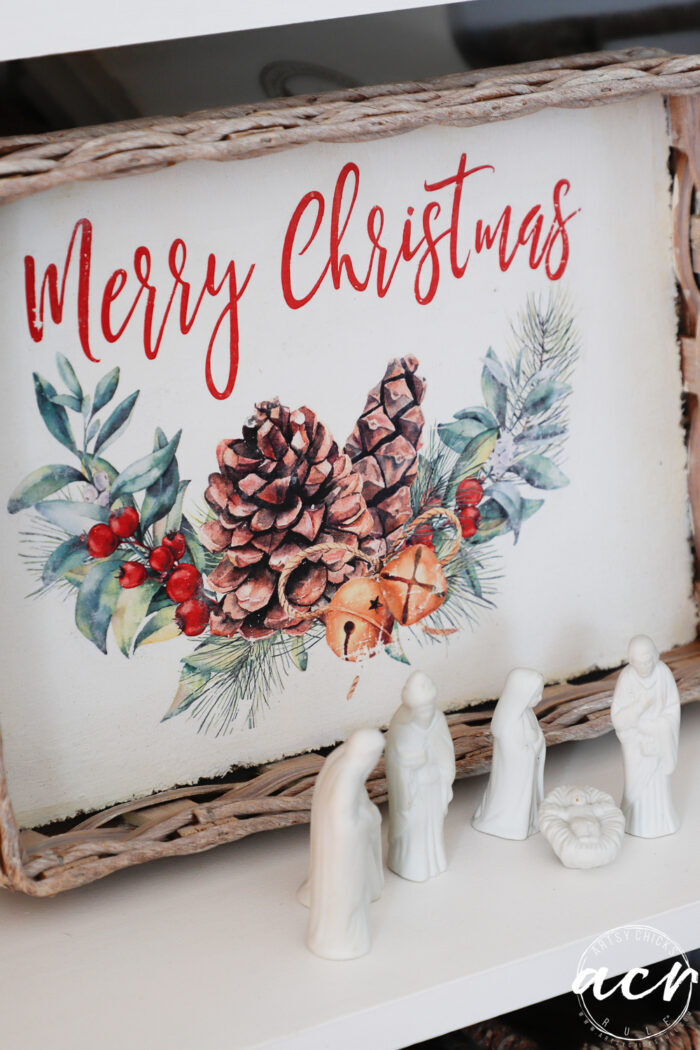 merry christmas picture on tray with white ceramic nativity in front