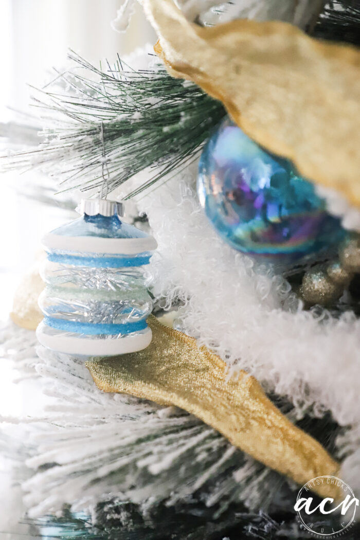 blue ornaments on tree up close