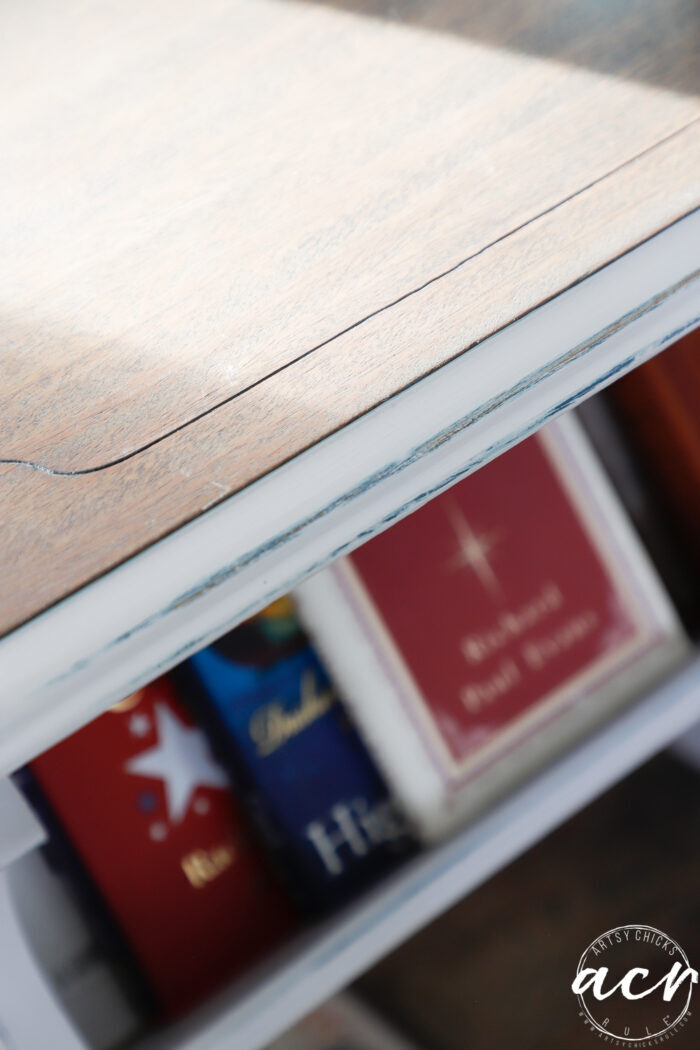 edge of side book table revealing blue distressed area