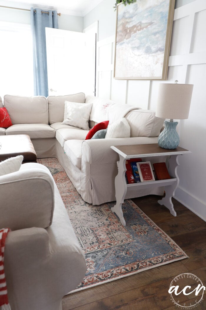 living room shot with couch and small side book table