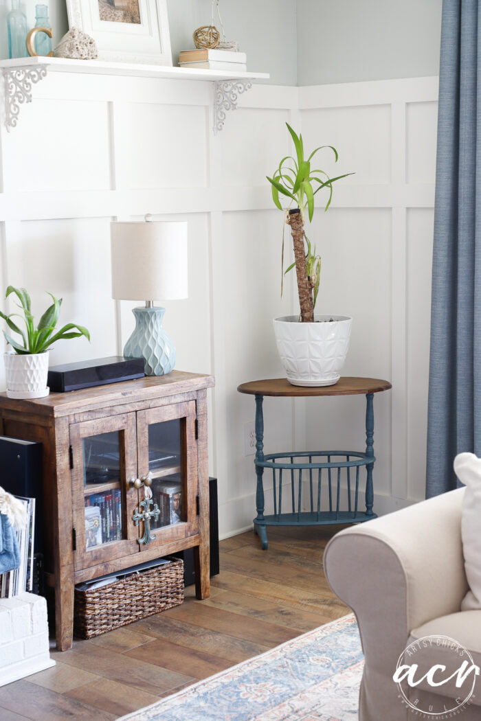 blue table with plant on top