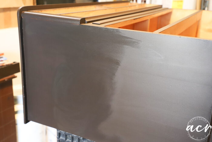 side of dresser showing half with stain half without