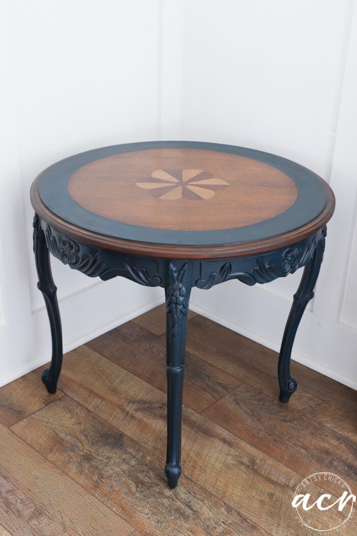 wood round side table that is stained and painted blue