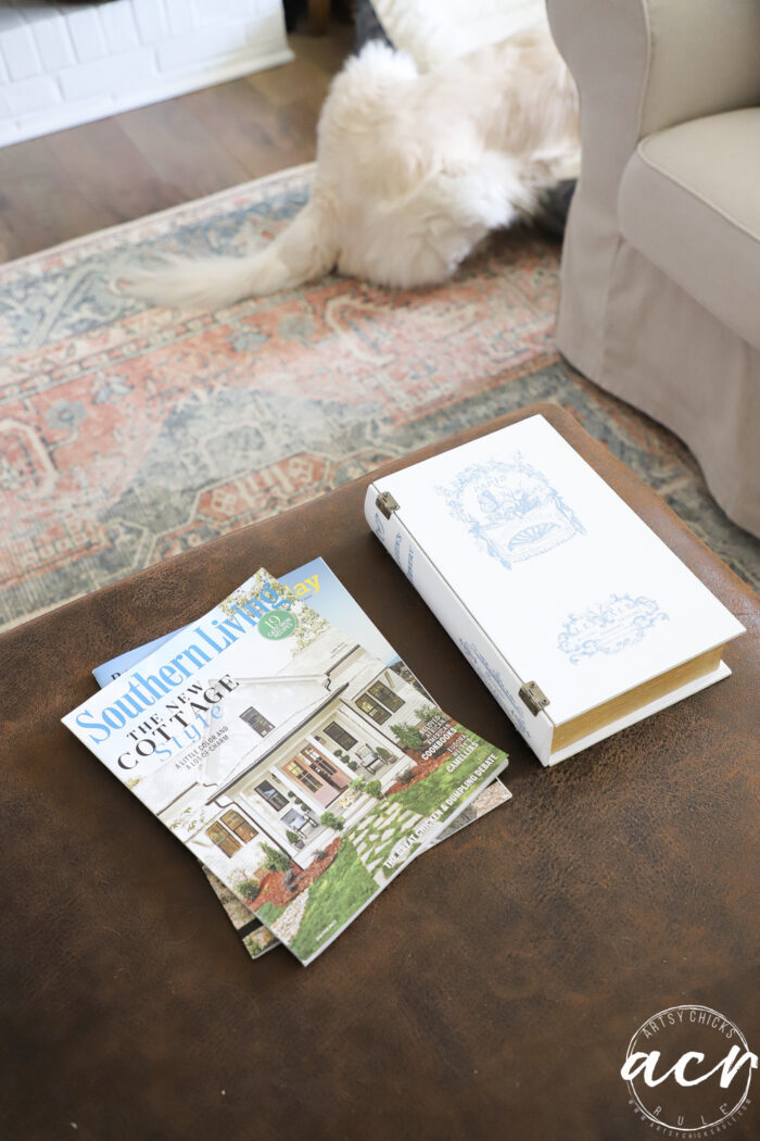 ottoman with hidden book storage, magazines and a dog's fluffy white butt