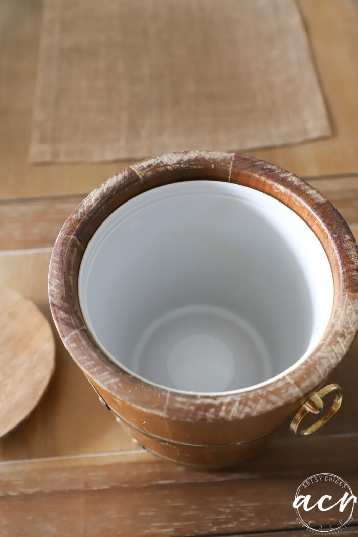 wood ice bucket on table with white plastic tub inside